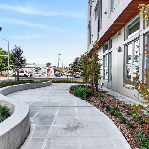 Sidewalk and exterior of modern apartment building