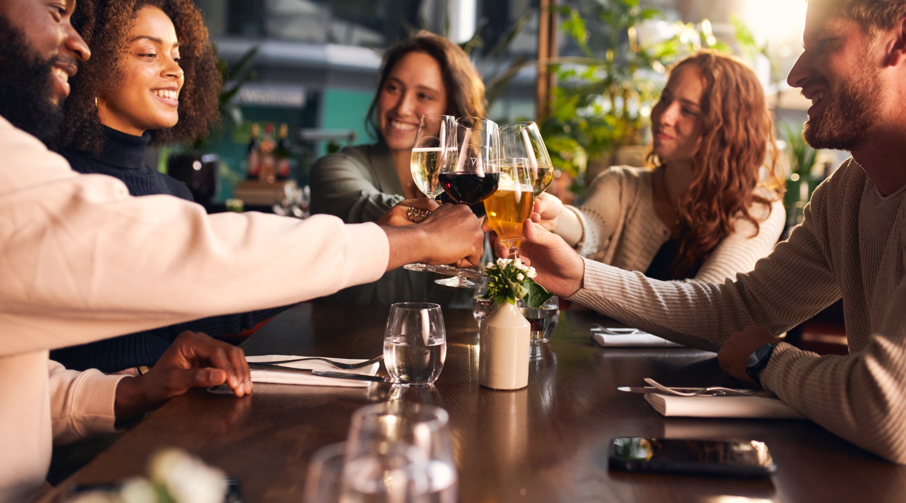 People at restaurant doing a cheers
