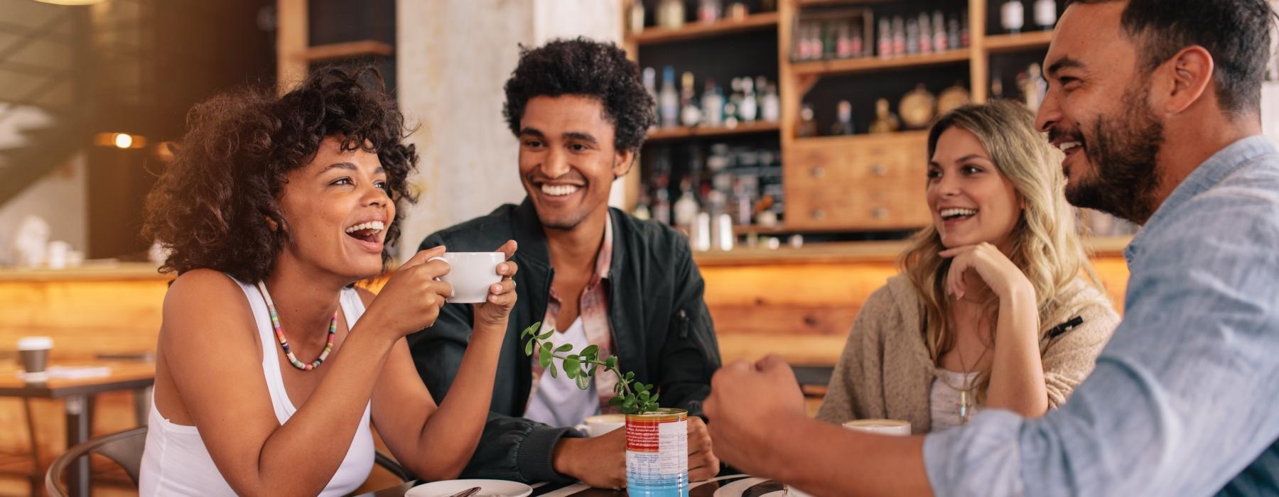 a group of people sitting at a restaurant table
