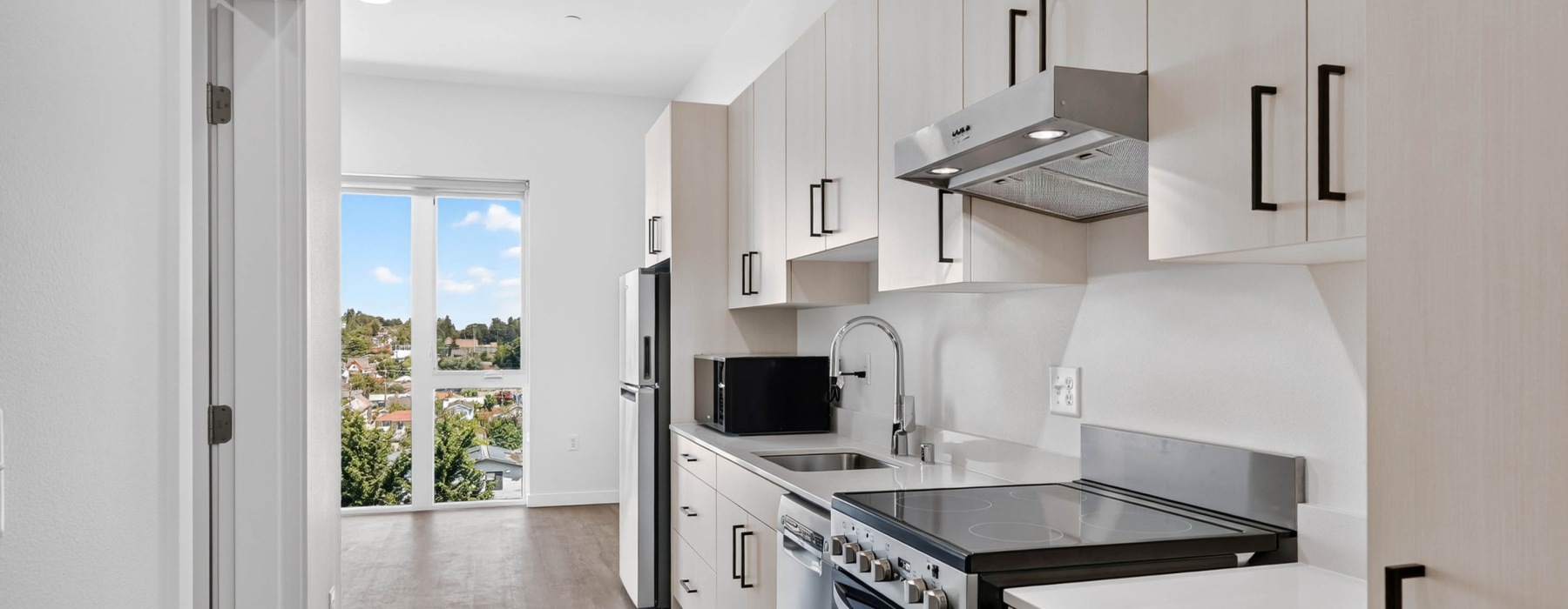 a modern kitchen with light cabinets