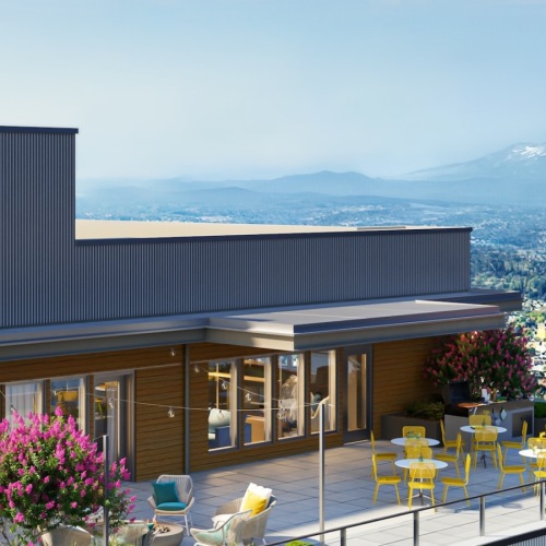 a rooftop balcony with a mountain in the background